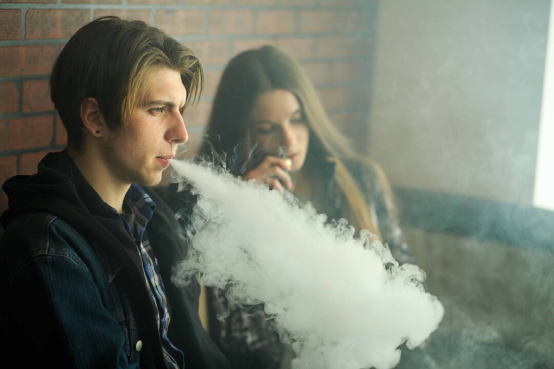 Young people vaping. (Shutterstock)