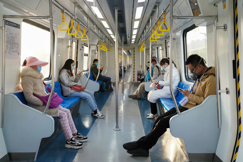 Commuters wear protective masks and keep their distance at subway during Monday rush hour in Beijing on April 13, 2020. (Lintao Zhang/Getty Images)