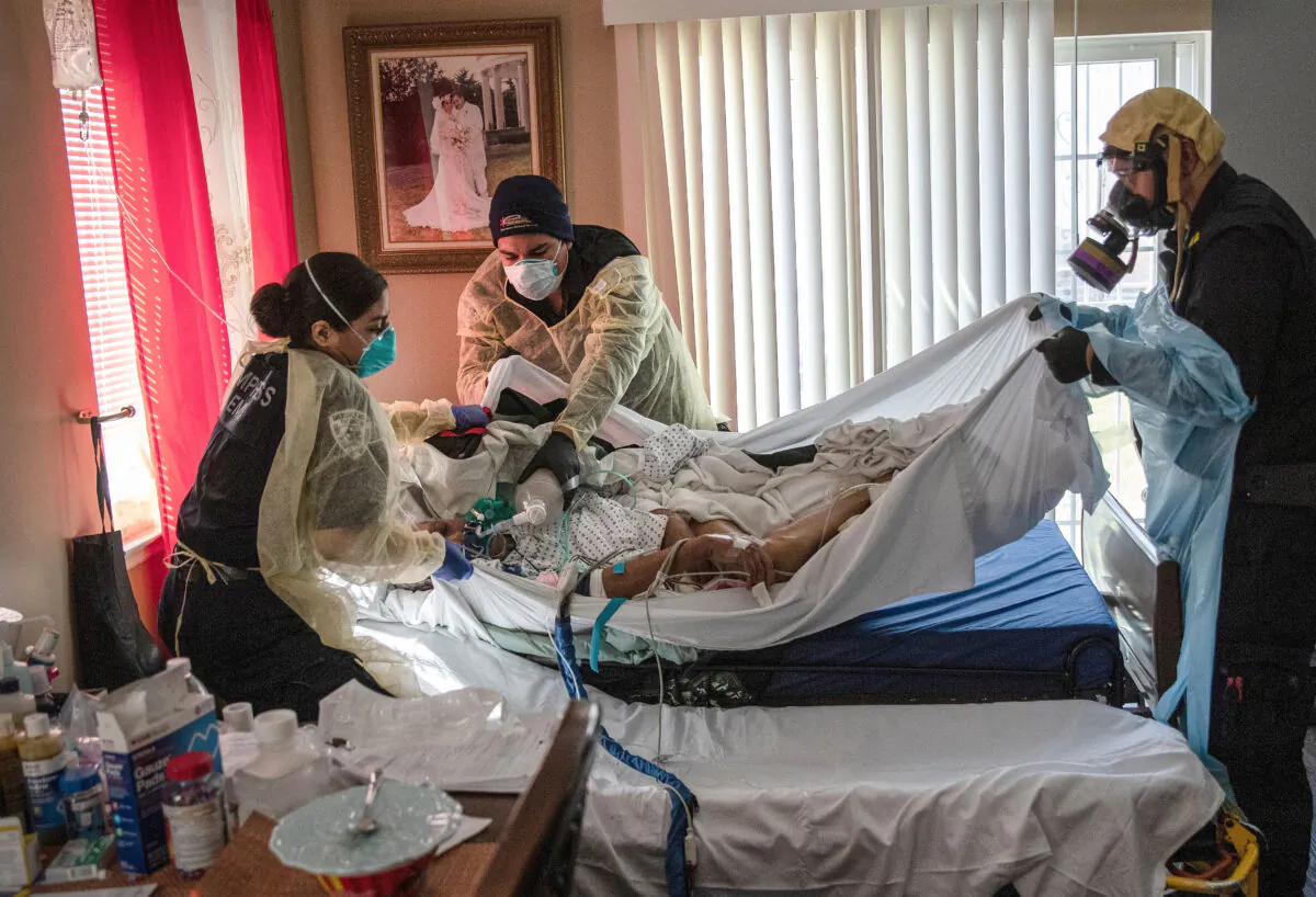 Paramedics and EMTs prepare to transport a gravely ill 92-year-old man with CCP virus symptoms from his home in Yonkers, New York, on April 6, 2020. (John Moore/Getty Images)