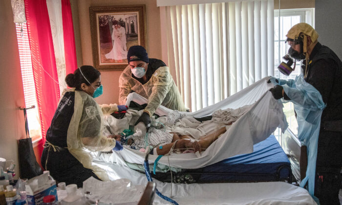 Paramedics and EMTs prepare to transport a gravely ill 92-year-old man with CCP virus symptoms from his home in Yonkers, New York, on April 6, 2020.  (John Moore/Getty Images)