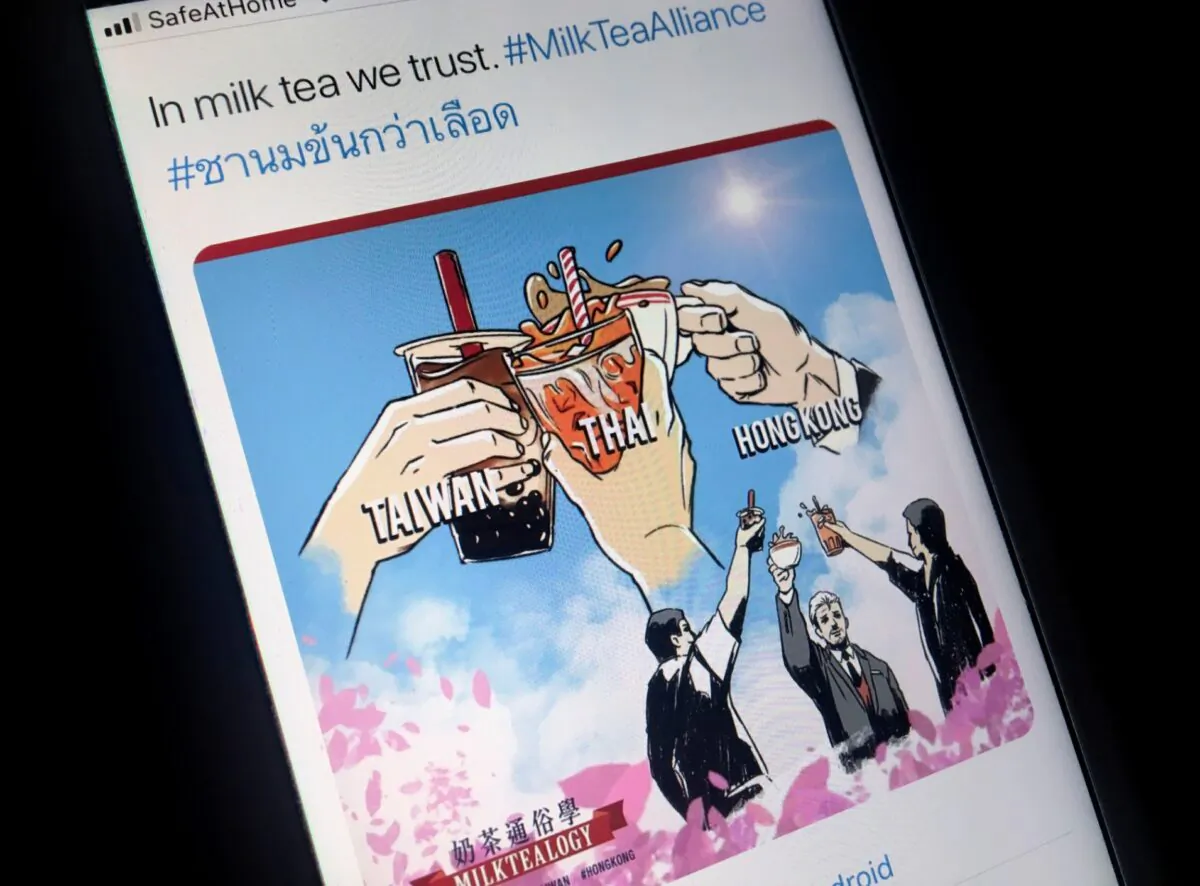 A mobile phone displays an internet meme of a growing online movement called "Milk Tea Alliance" to show solidarity between Thailand, Taiwan and Hong Kong, in this illustration taken on April 15, 2020. (Patpicha Tanakasempipat/Illustration/Reuters)