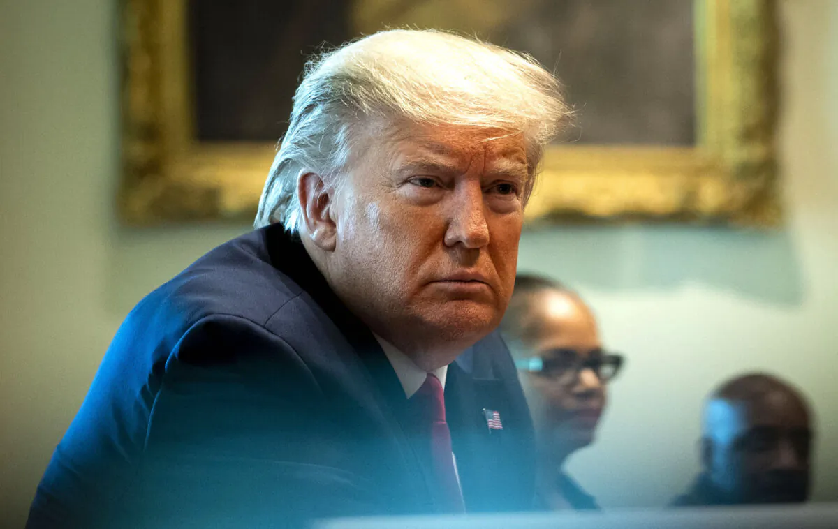 President Donald Trump listens during a meeting with recovered CCP virus patients in the Cabinet Room at the White House on April 14, 2020. (Doug Mills-Pool/Getty Images)