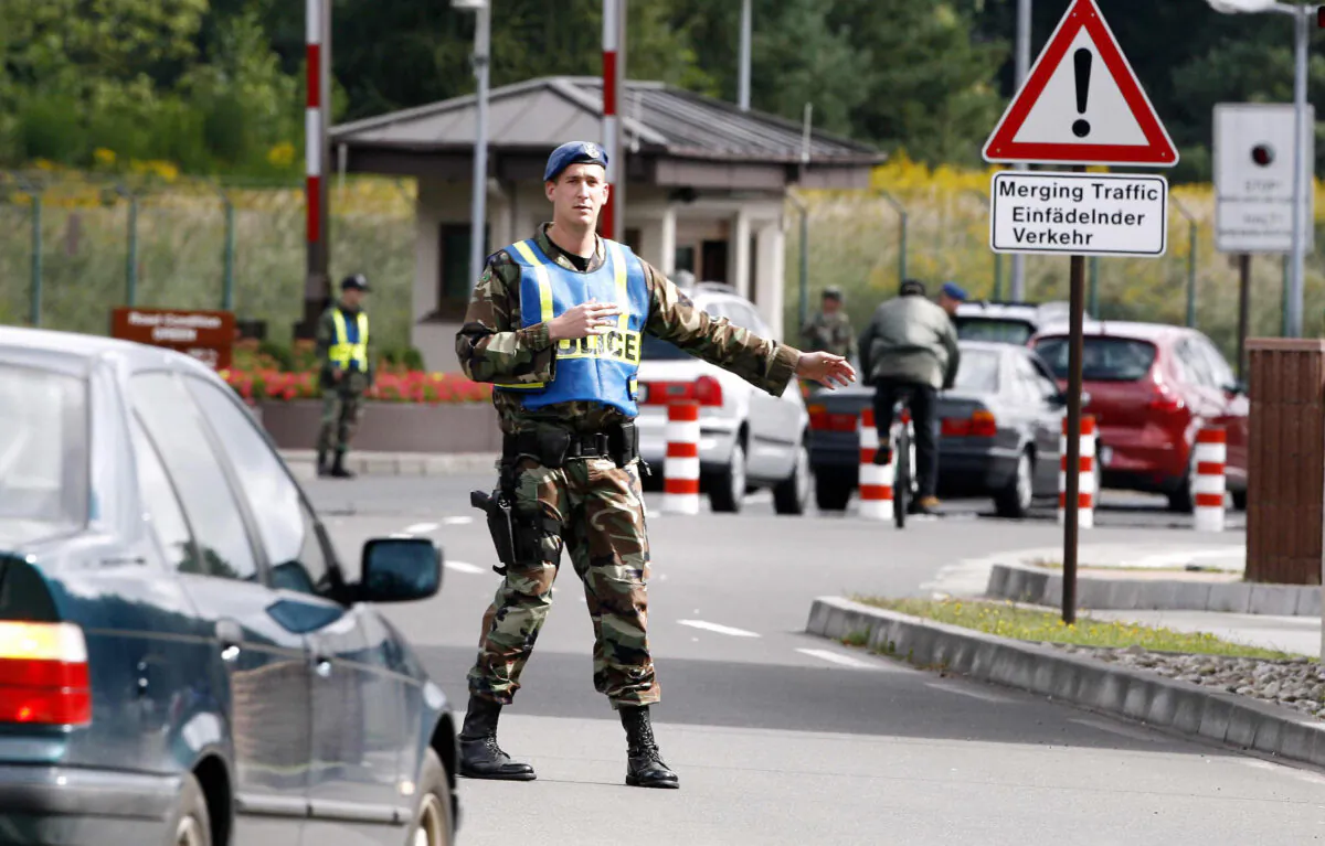 In this file image, US military police control a cars entering the US - airbase in Ramstein, 05 September 2007, (Torsten Silz/DDP/AFP via Getty Images)