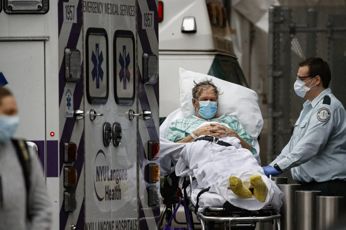 Patients and medical workers wear personal protective equipment due to COVID-19 concerns outside the emergency room at NYU Langone Medical Center in New York City on April 13, 2020. (John Minchillo/AP Photo)