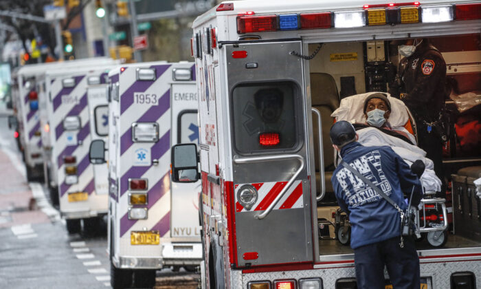 A patient arrives in an ambulance cared for by medical workers wearing personal protective equipment due to COVID-19 concerns outside NYU Langone Medical Center in New York on Apr. 13,2020.(John Minchillo/AP)
