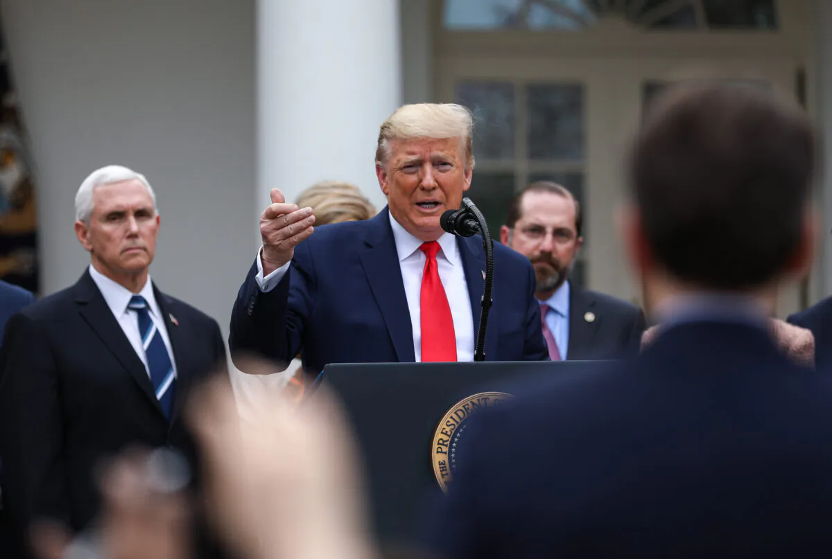 President Donald Trump, flanked by officials and business leaders, announces a national emergency with regard to the coronavirus in the White House Rose Garden in Washington on March 13, 2020. (Charlotte Cuthbertson/The Epoch Times)
