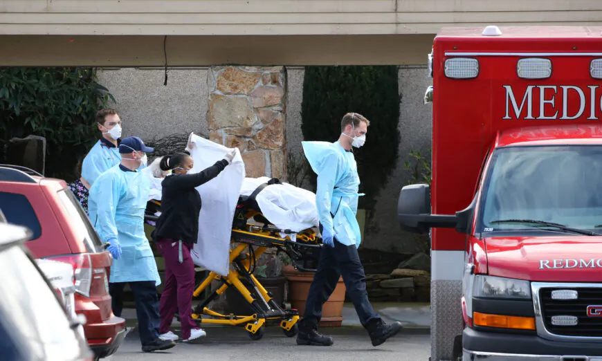 A patient is transferred into an ambulance at the Life Care Center in Kirkland, Washington, on March 7, 2020. (Karen Ducey/Getty Images)