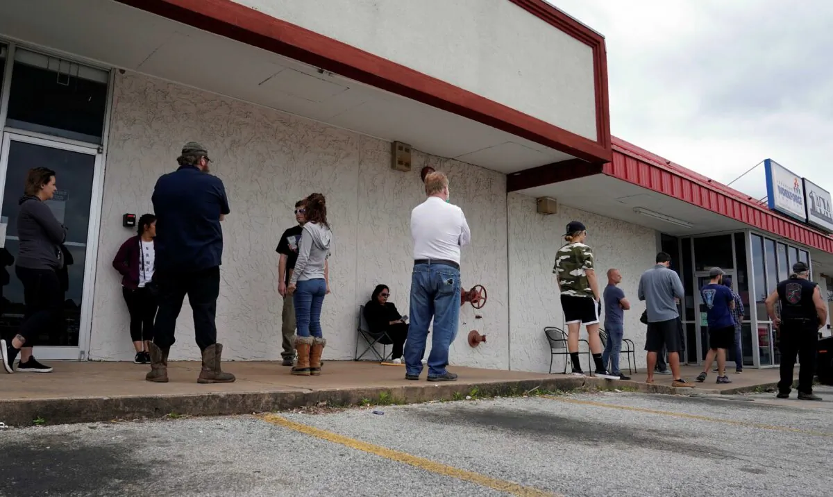 People who lost their jobs wait in line to file for unemployment following an outbreak of COVID-19 at an Arkansas Workforce Center in Fayetteville, Arkansas, on April 6, 2020. (Nick Oxford/Reuters)