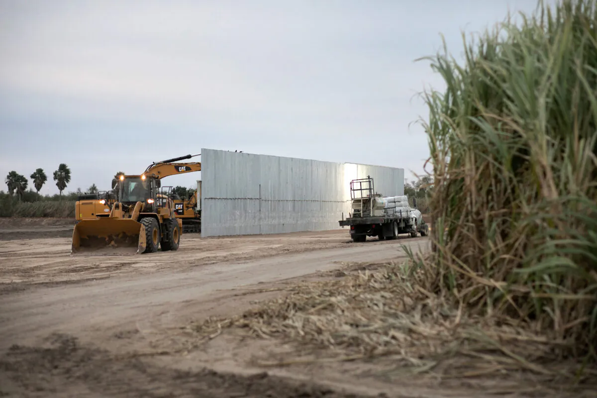A loader grades land near a section of privately built border wall under construction near Mission, Texas, on Dec. 11, 2019. (John Moore/Getty Images)