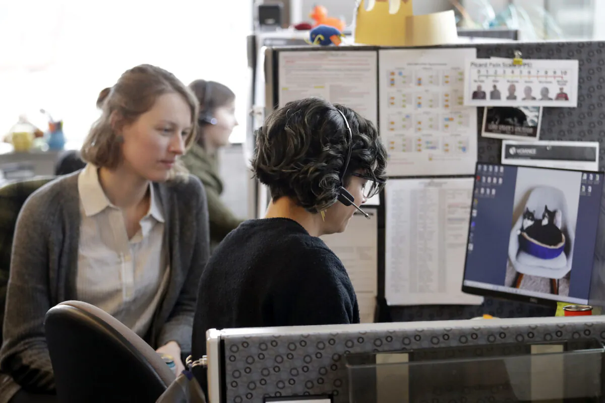 Nurse Jennifer Morgan, right, checks in via phone with a patient self-quarantined at home who had some risk of exposure to COVID-19 as Erika Feutz observes at a public health facility used for contact tracing in Seattle, Wash., on Feb.13, 2020. (Elaine Thompson/AP)