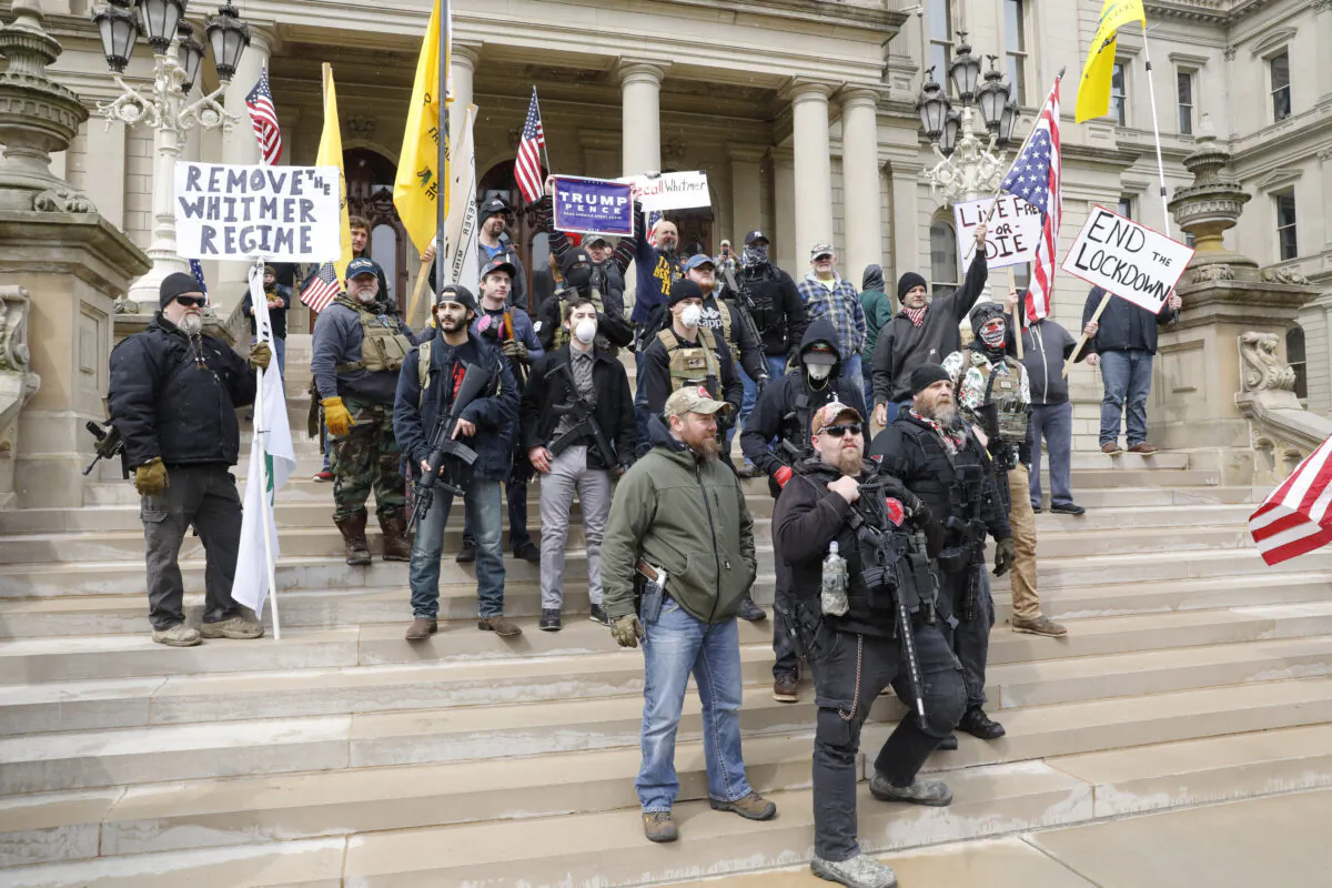 People take part in a protest for "Michiganders Against Excessive Quarantine" at the Michigan State Capitol in Lansing, Michigan on April 15, 2020. (Jeff Kowalsky/AFP via Getty Images)