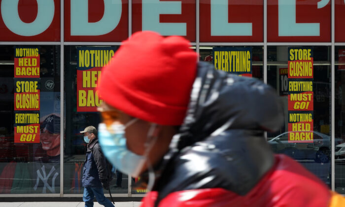 A man rides past a closed Modell's in New York City on April 15, 2020. (Bryan R Smith/Reuters)