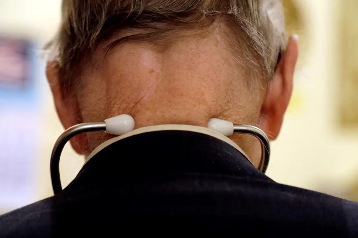 A doctor wears a stethoscope around his neck as he tends to patients in his office this file photo. (The Canadian Press/Jeff Roberson)