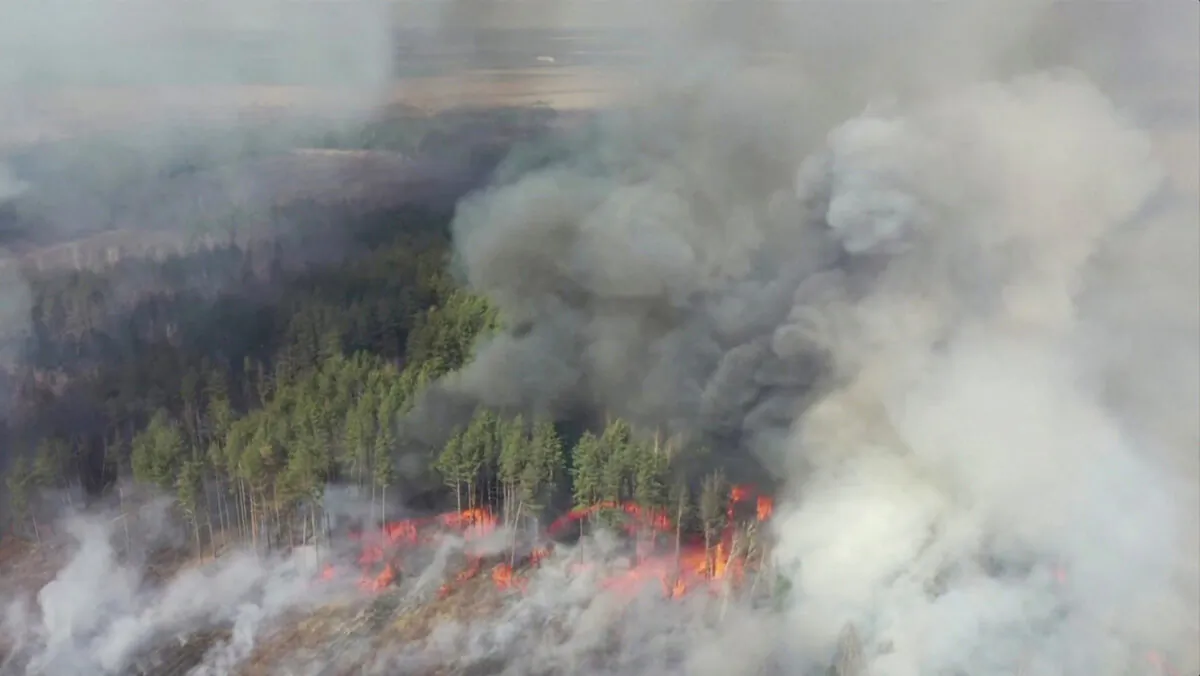 FILE PHOTO: An aerial view shows a forest fire in the 30 km (19 mile) exclusion zone around the Chernobyl nuclear power plant in this still picture taken from video in Ukraine on April 12, 2020. Video taken April 12, 2020. (Reuters TV)