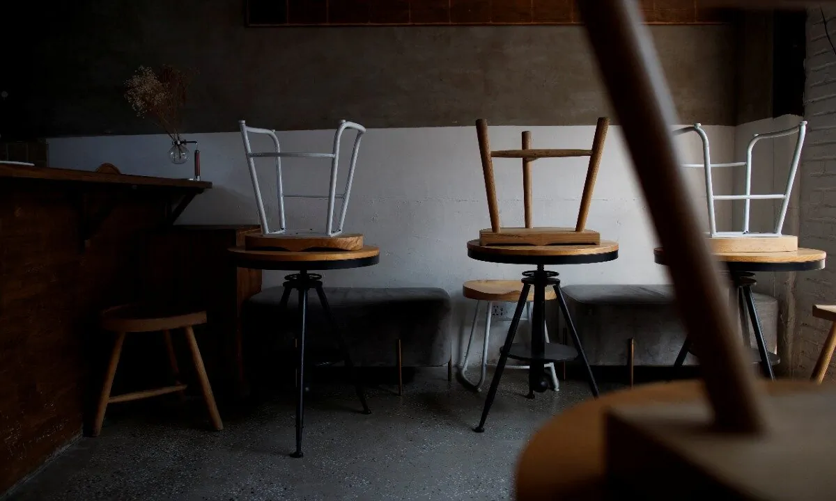 Stools are turned upside down in a cafe that is closed for regular business but open for takeout in the Wudaoying Hutong, one of the top tourist destinations in Beijing, as the spread of the CCP virus continues in China, on April 10, 2020. (Thomas Peter/Reuters)