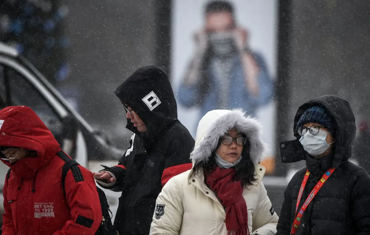 Chinese tourists walk along a street in Moscow on January 29, 2020. (ALEXANDER NEMENOV/AFP via Getty Images)