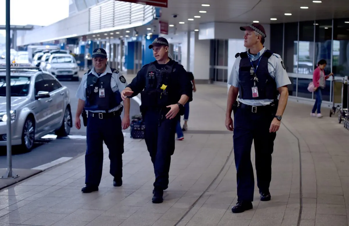Police walk outside the international terminal as they patrol Sydney Airport on July 31, 2017. (PETER PARKS/AFP via Getty Images)