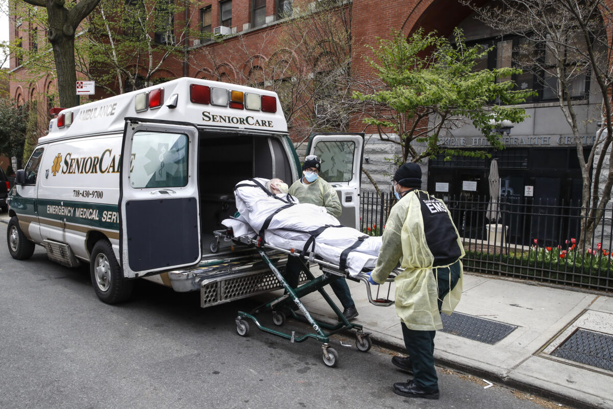 A patient is loaded into the back of an ambulance
