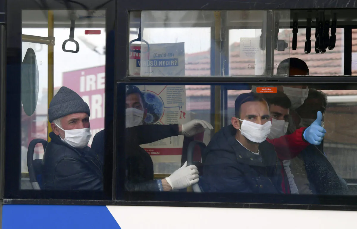 Prisoners sit in a bus in Sincan outside Ankara, Turkey on April 15, 2020. (AP)