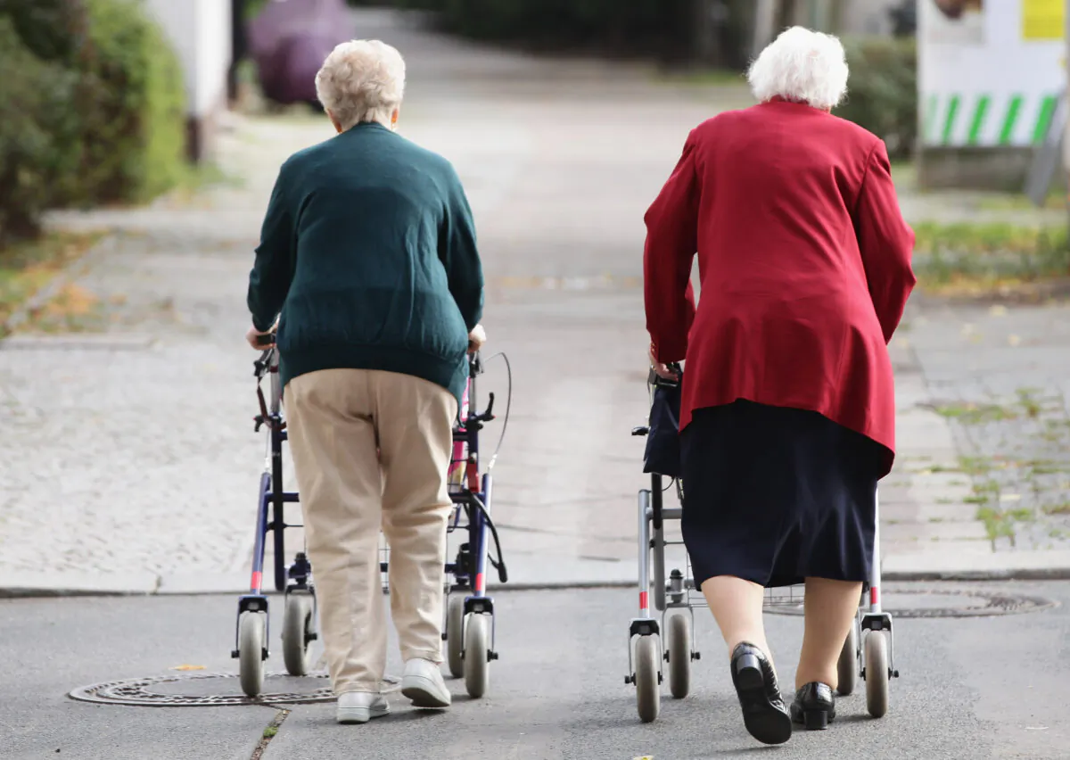 BERLIN - SEPTEMBER 10:  Two elderly women push shopping carts down a street on September 10, 2010 in Berlin, Germany.  (Sean Gallup/Getty Images)