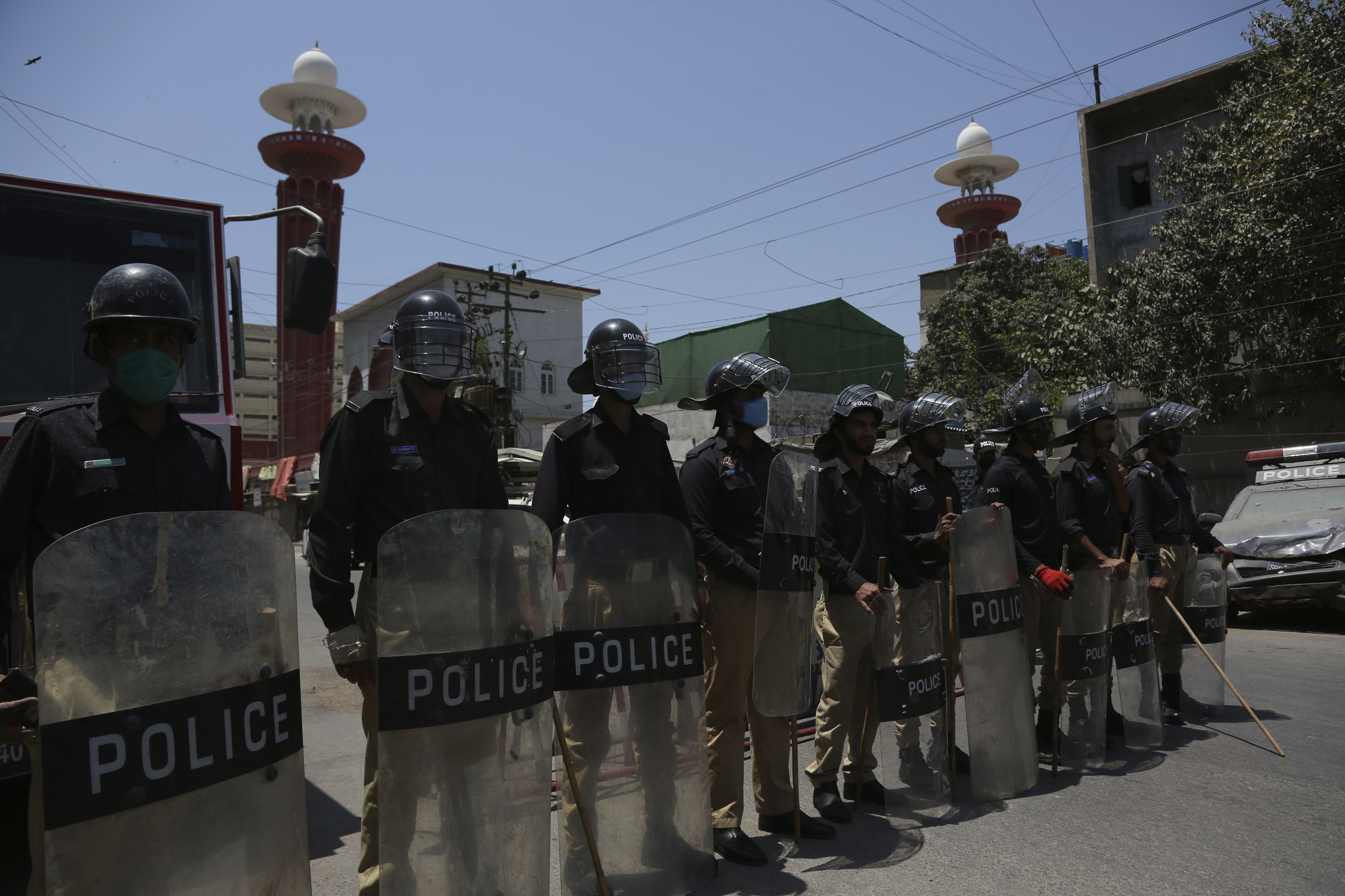 Police officers stand guard outside a mosque during a nation-wide lock down as a preventive measure against the outbreak of CCP virus, in Karachi, Pakistan, April 17, 2020.