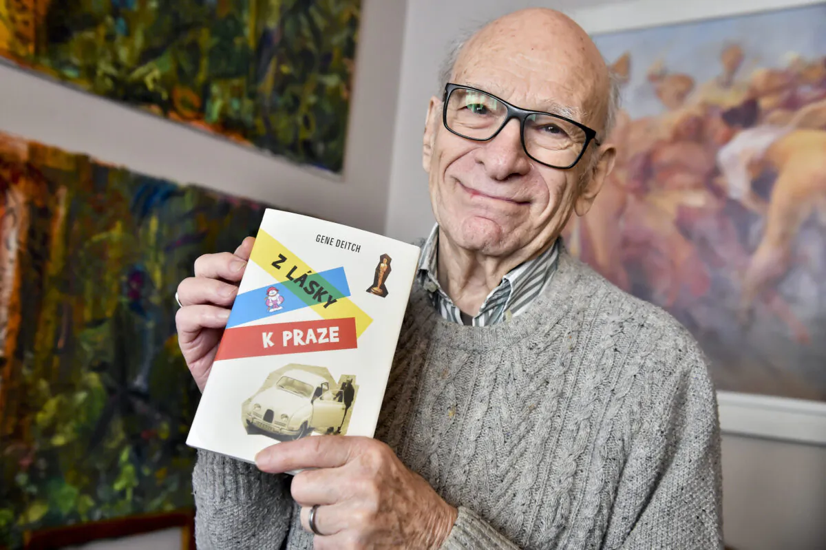 American director and animated film producer Gene Deitch poses for the photographer with his book of memories 'For the Love of Prague' in Prague, Czech Republic on Feb. 20, 2018. (Vit Simanek/CTK via AP, file)