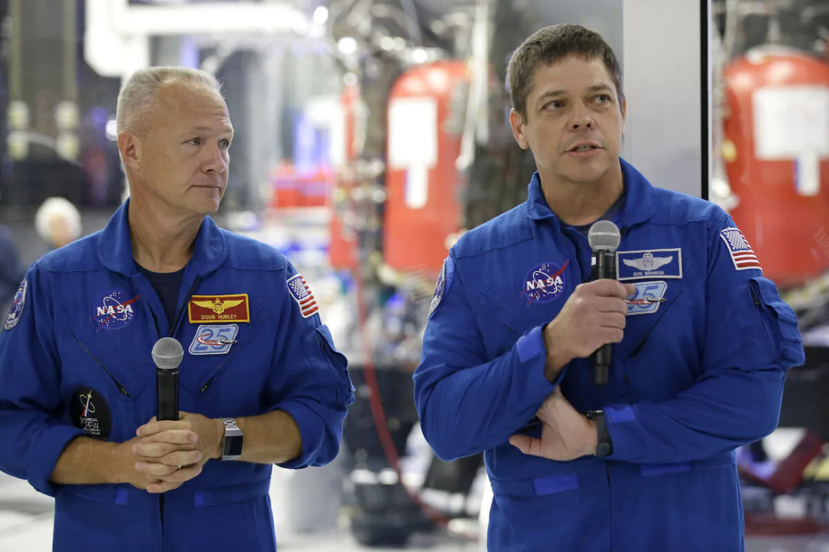 NASA astronauts Bob Behnken, right, with Doug Hurley talk to the media in front of the Crew Dragon spacecraft, about the progress to fly astronauts to and from the International Space Station, from American soil, as part of the agency’s commercial crew program at SpaceX headquarters, in Hawthorne, Calif., on Oct. 10, 2019. (Alex Gallardo/AP Photo)