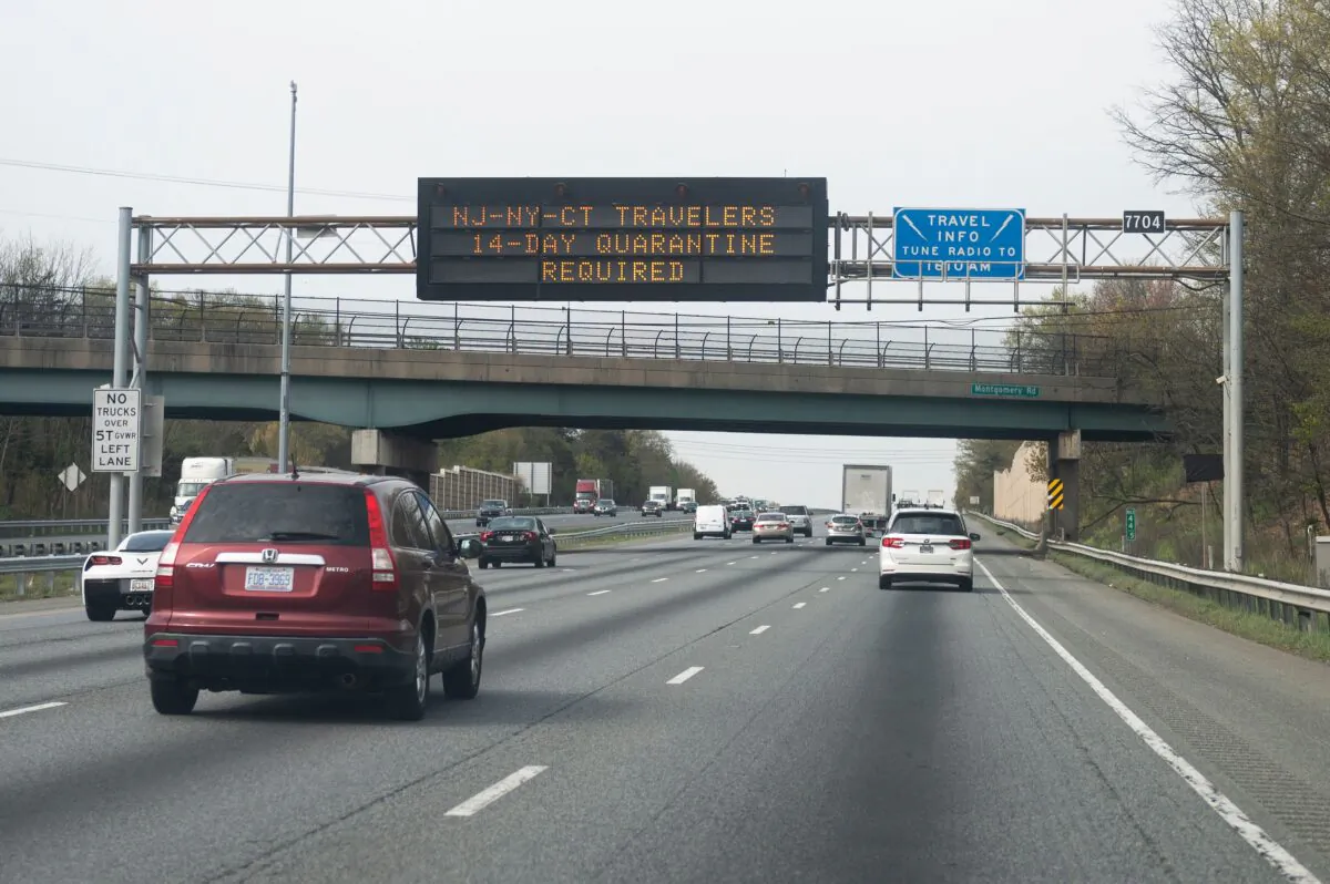 Cars drive below a sign on the highway notifying travelers from New York, New Jersey, or Connecticut that they are required to quarantine for 14 days, in Millersville, Maryland on April 17, 2020. (Andrew Caballero-Reynolds/AFP via Getty Images)