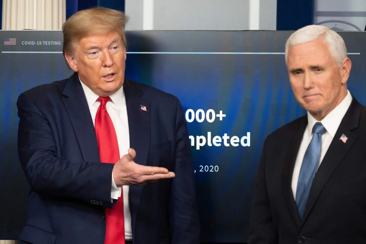 President Donald Trump gestures to Vice President Mike Pence during the daily briefing on the CCP virus in the Brady Briefing Room of the White House in Washington on April 17, 2020. (Jim Watson/AFP via Getty Images)
