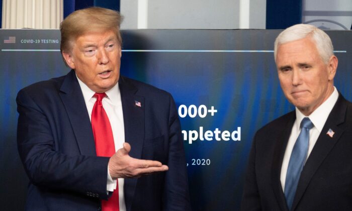 President Donald Trump gestures to Vice President Mike Pence during the daily briefing on the CCP virus in the Brady Briefing Room of the White House in Washington on April 17, 2020. (Jim Watson/AFP via Getty Images)