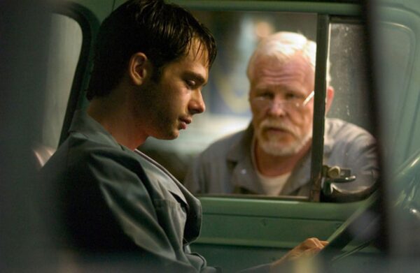 young and old man talking in and out of car