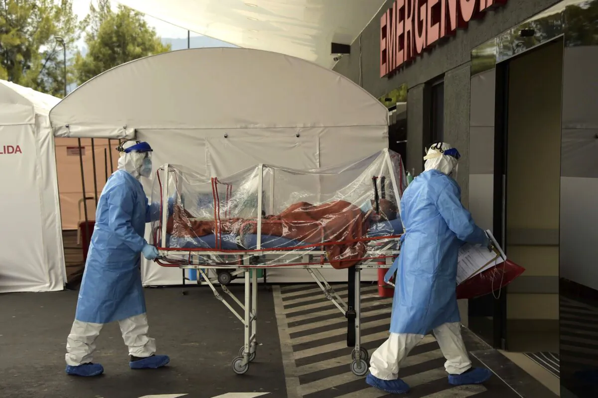 A patient who tested positive to the novel coronavirus is taken on a stretcher into the emergency room of the IESS Sur Hospital in Quito, Ecuador, on April 18, 2020. (Rodrigo Buendia/AFP via Getty Images)