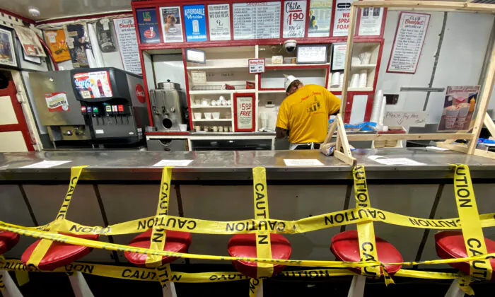 An employee prepares a take away order at a fast food restaurant as the spread of the CCP virus affected local business in Roanoke, Va., on April 18, 2020. (Carlos Barria/Reuters)