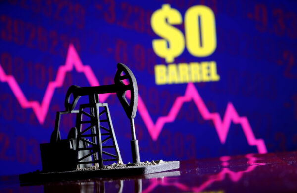 A 3D-printed oil pump jack is seen in front of displayed stock graph and "$0 Barrel" words in this illustration picture