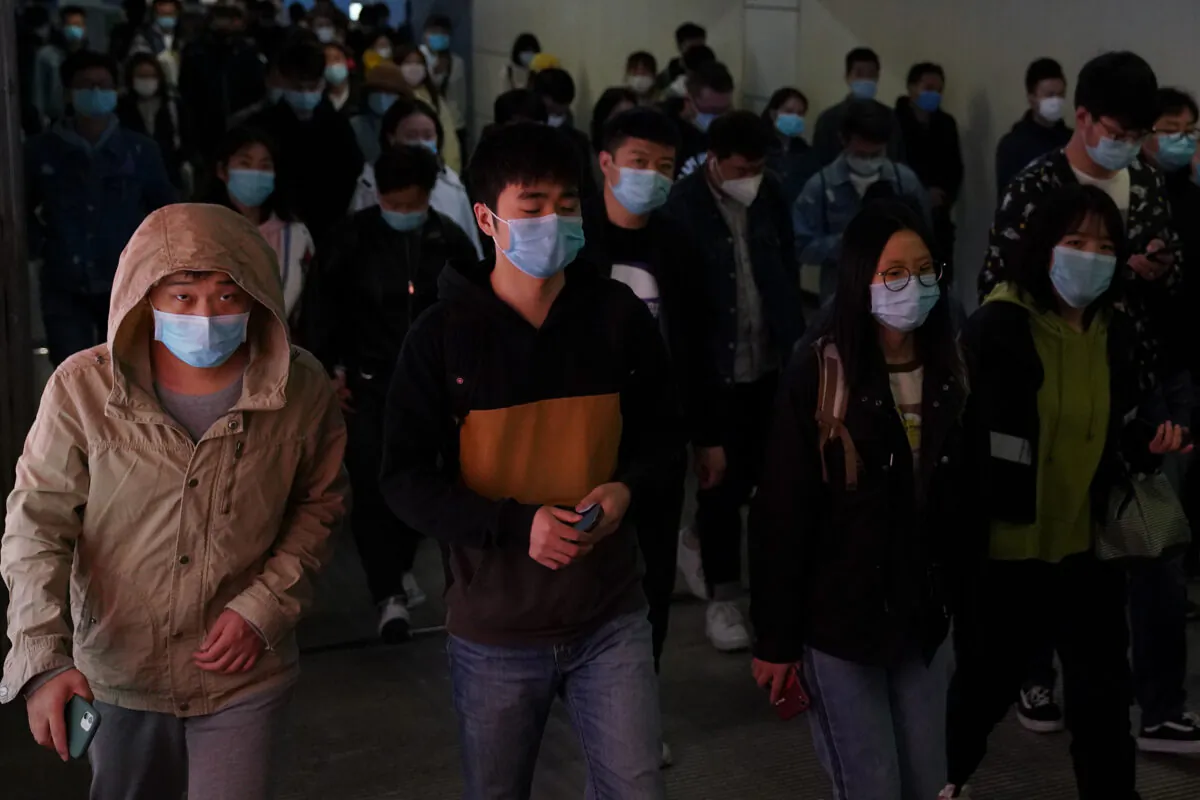 Commuters wear protective masks as they exit a train at a subway station during rush hour in Beijing, China on April 20, 2020. (Lintao Zhang/Getty Images)