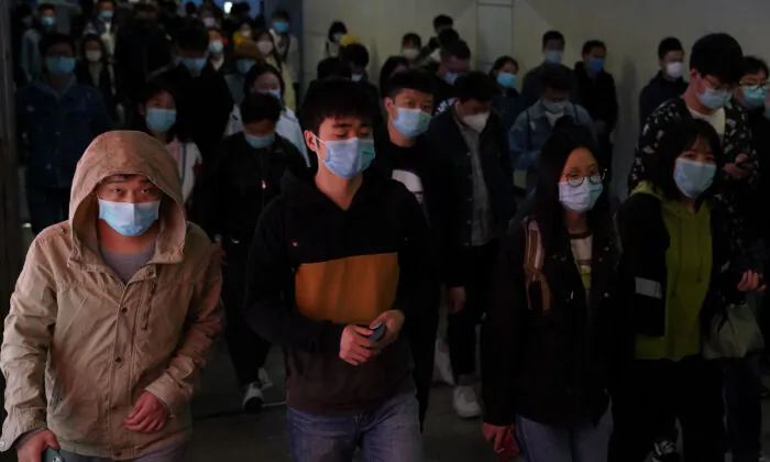 Commuters wear protective masks as they exit a train at a subway station during rush hour in Beijing, China on April 20, 2020. (Lintao Zhang/Getty Images)