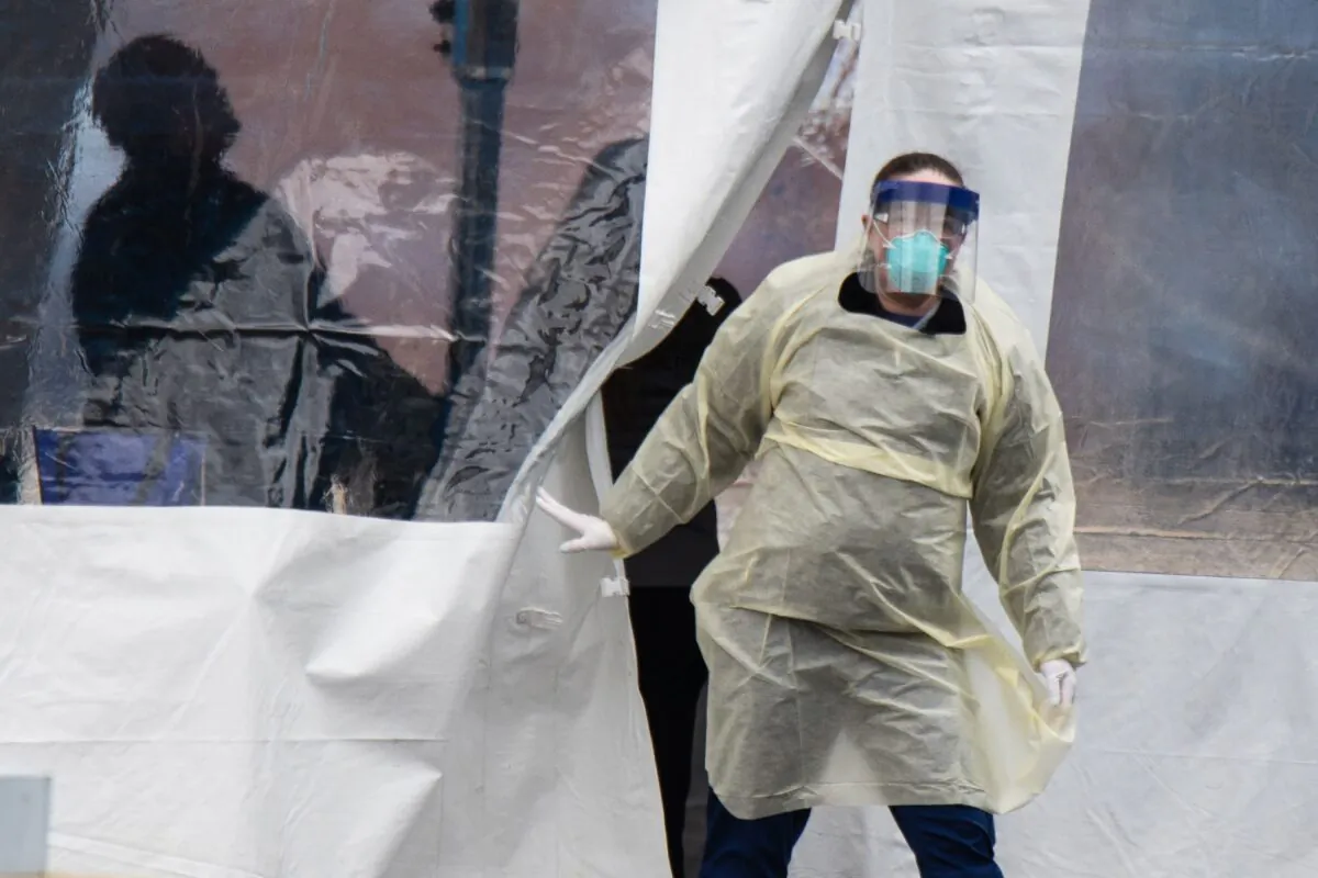 A health professional walks out of a drive-thru coronavirus testing site at the University of Dayton in Dayton, Ohio, on March 17, 2020. (MEGAN JELINGER/AFP via Getty Images)