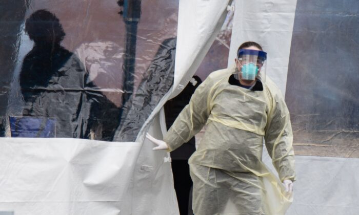 A health professional walks out of a drive-thru coronavirus testing site at the University of Dayton in Dayton, Ohio, on March 17, 2020.   (MEGAN JELINGER/AFP via Getty Images)