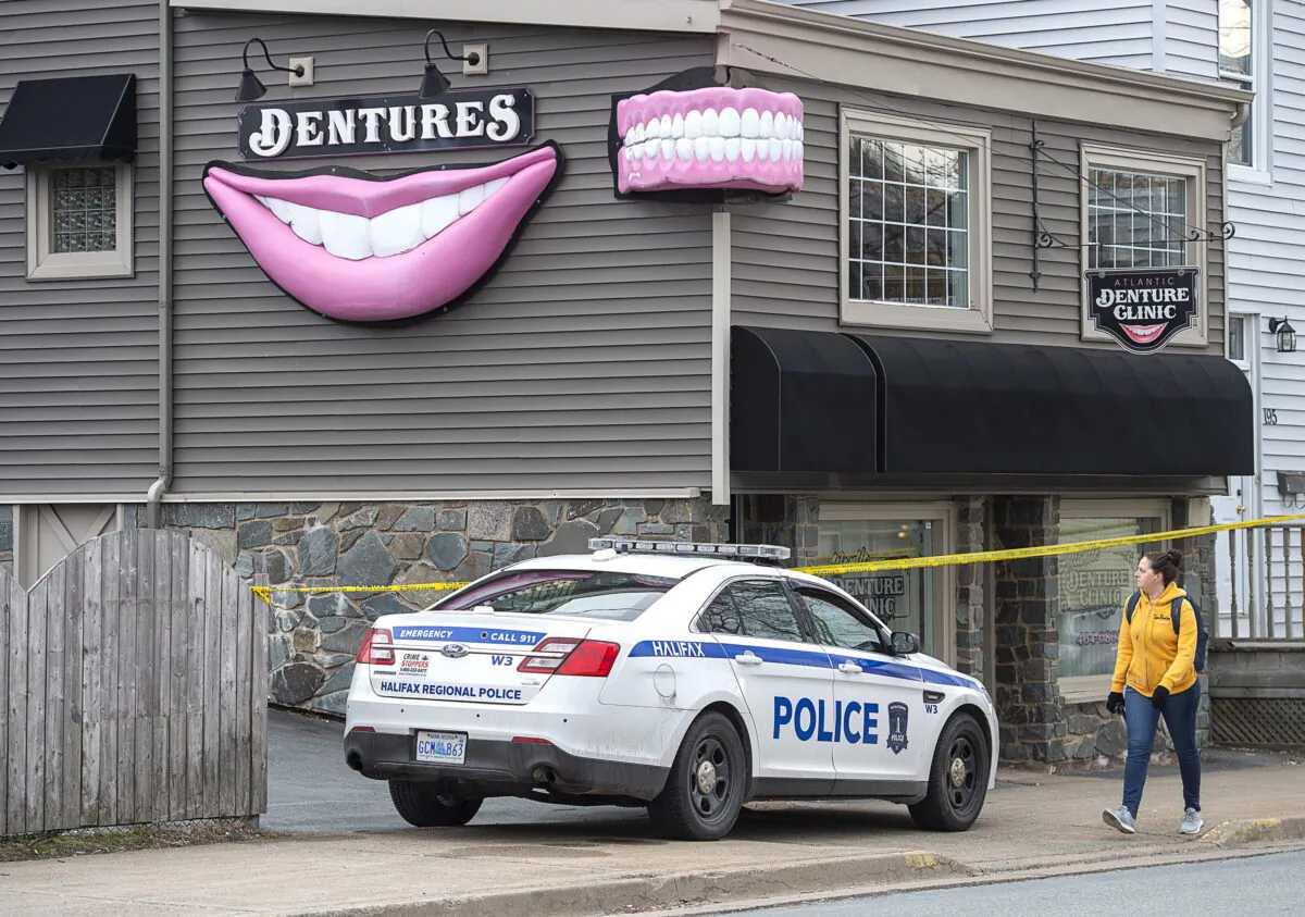 The Atlantic Denture Clinic is guarded by police in Dartmouth, N.S., Canada, on April 20, 2020. (Andrew Vaughan/The Canadian Press)