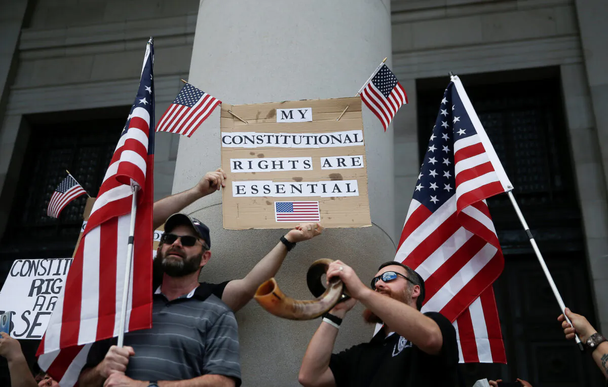 Demonstrators protest an extended stay-at-home order at the Capitol building in Olympia, Wash., on April 19, 2020. (Reuters/Lindsey Wasson)