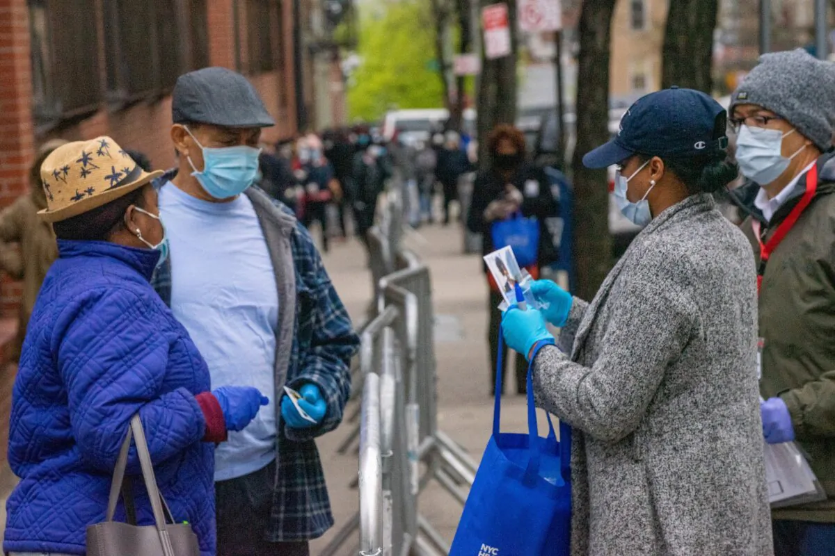 People stand in line for COVID-19 testing at NYC Health + Hospitals/Gotham Health, Morrisania in the Bronx borough of New York City on April 20, 2020. (David Dee Delgado/Getty Images)
