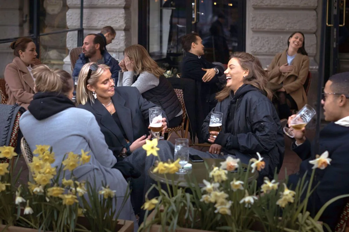 People socialize at a pub in Stockholm, Sweden, on April 8, 2020. Swedish authorities have advised the public to practice social distancing due to the pandemic, but still allow a large amount of personal freedom. (Andres Kudacki/AP Photo)