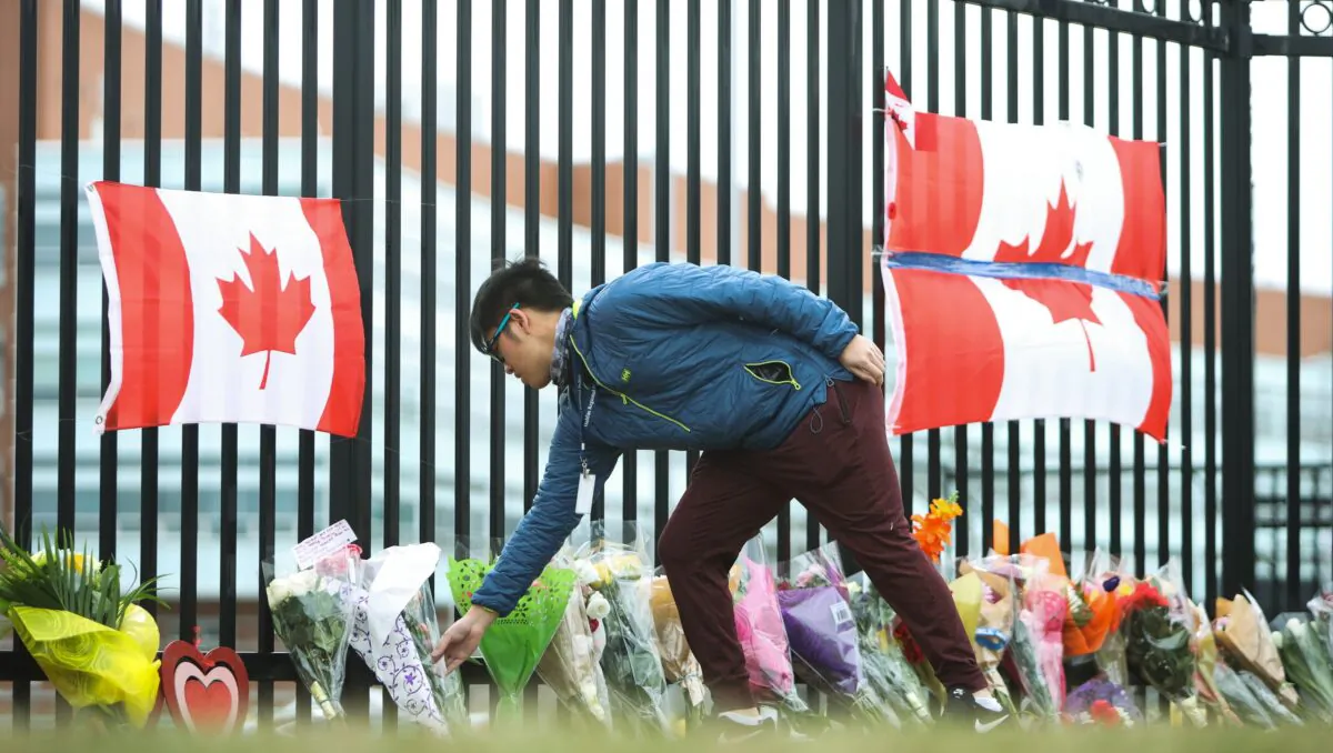 A person leaves flowers at a make-shift memorial dedicated to Constable Heidi Stevenson at RCMP headquarters in Dartmouth, Nova Scotia, on April 20, 2020. (The Canadian Press/Riley Smith)