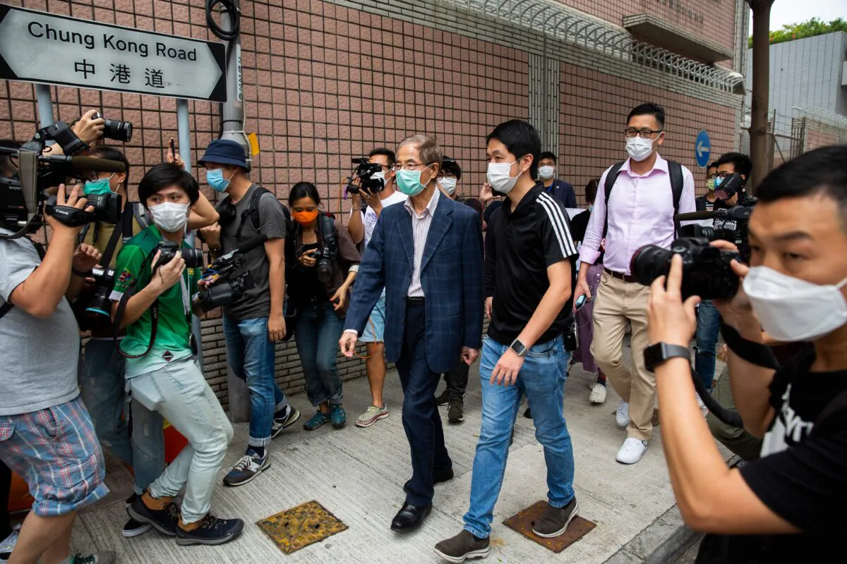 Former lawmaker and pro-democracy activist Martin Lee (C) leaves the Central District police station, after being arrested and accused of organising and taking part in an unlawful assembly in August last year, in Hong Kong on April 18, 2020. (ISAAC LAWRENCE/AFP via Getty Images)