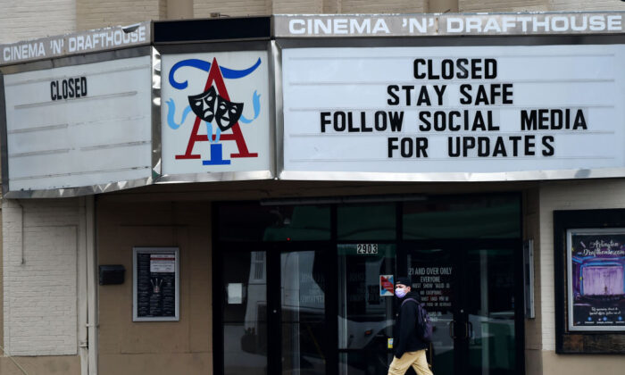 A man wearing a face mask to protect himself from the coronavirus walks past a closed theater in Arlington, Virginia on April 18, 2020. ( Olivier Douliery/AFP via Getty Images)