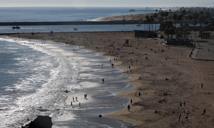 People are seen along Corona del Mar State Beach in Newport Beach, Calif., on April 15, 2020. Southern California has seen warmer weather over the last few days as social distance guidelines due to COVID-19 are still in place. (Michael Heiman/Getty Images)