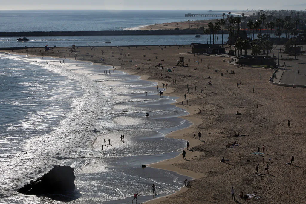 People are seen along Corona del Mar State Beach in Newport Beach, Calif., on April 15, 2020. Southern California has seen warmer weather over the last few days as social distance guidelines due to COVID-19 are still in place. (Michael Heiman/Getty Images)