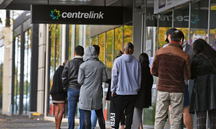 People queue up outside a Centrelink office for government payments in Melbourne on April 20, 2020. (William West/AFP via Getty Images ) 