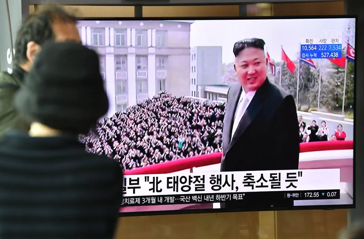 People watch a television news broadcast showing file footage of North Korean leader Kim Jong Un, at a railway station in Seoul, South Korea, on April 14, 2020. (Jung Yeon-Je/AFP via Getty Images)