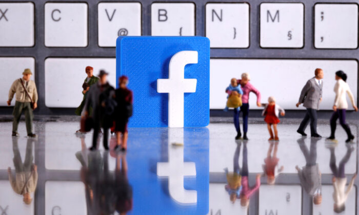 A 3D printed Facebook logo and toy people figures in front of a keyboard in this illustration taken on April 12, 2020. (Dado Ruvic/Illustration/Reuters)